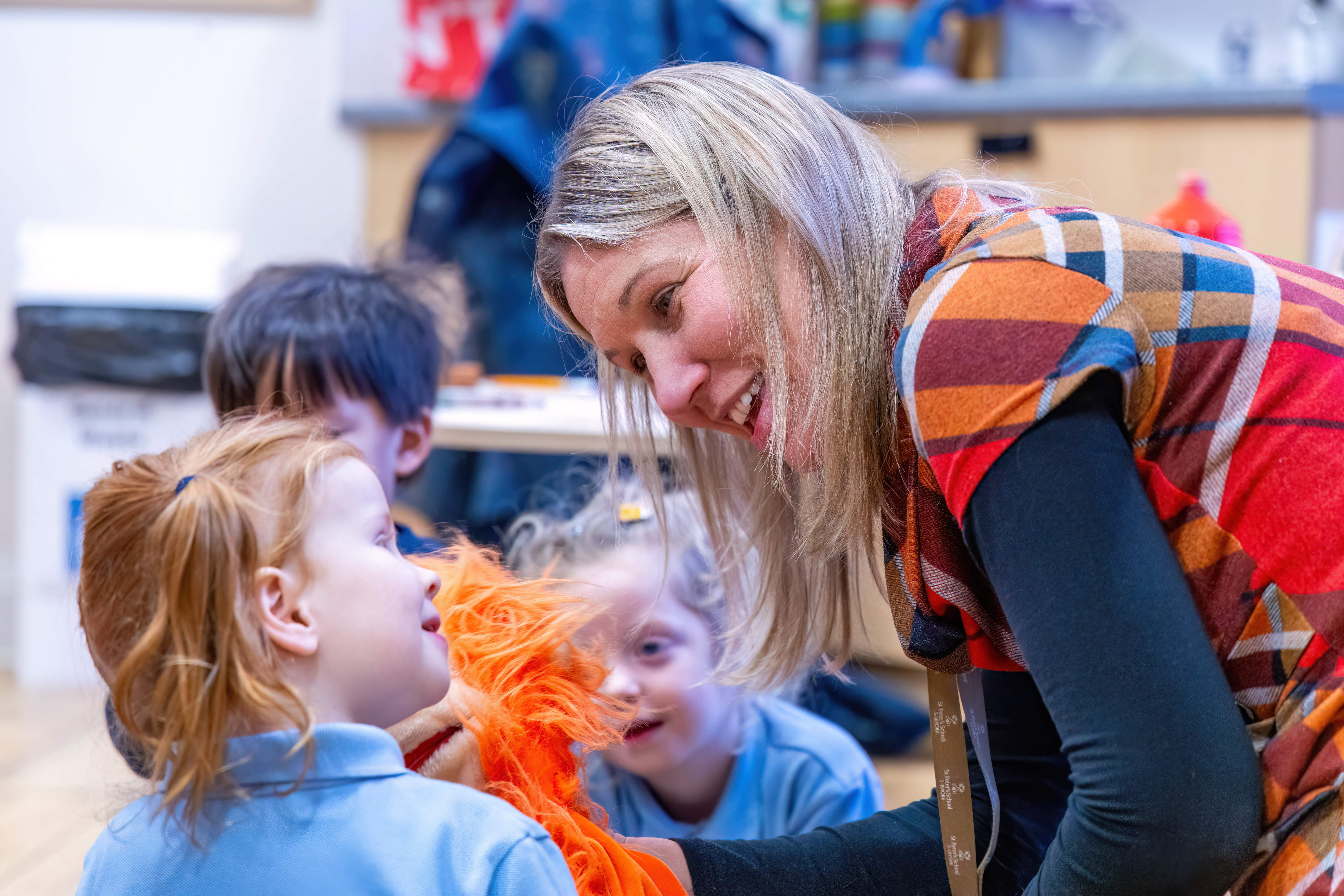 children playing in snow with teacher